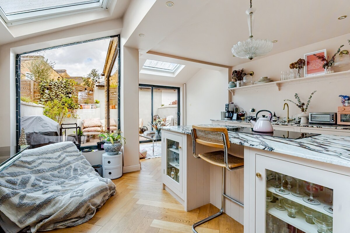 Kitchen extension with skylights opening to a courtyard garden